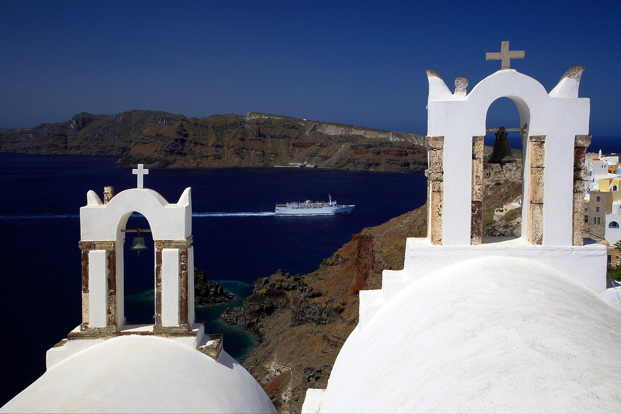 #060294-1 - Church Bell Towers overlooking Coastline, Oia, Santorini, Greece