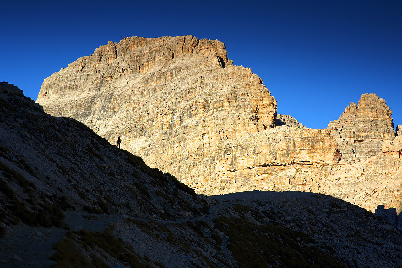 #060597-2 - Silhouette of Person against Mountain Cliff, Dolomites, Italy