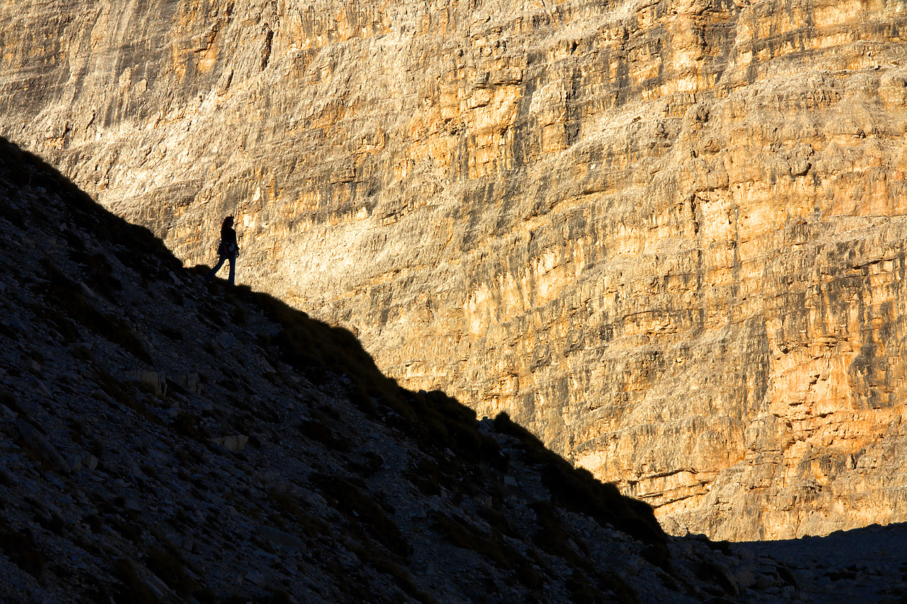 #060597-3 - Silhouette of Person against Mountain Cliff, Dolomites, Italy