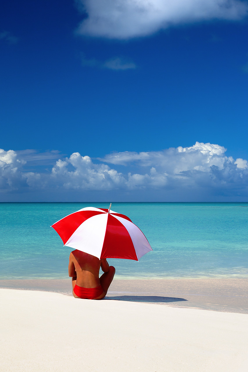 #070003-4 - Woman Sitting on Beach with Red & White Umbrella, Barbuda, Caribbean, West Indies
