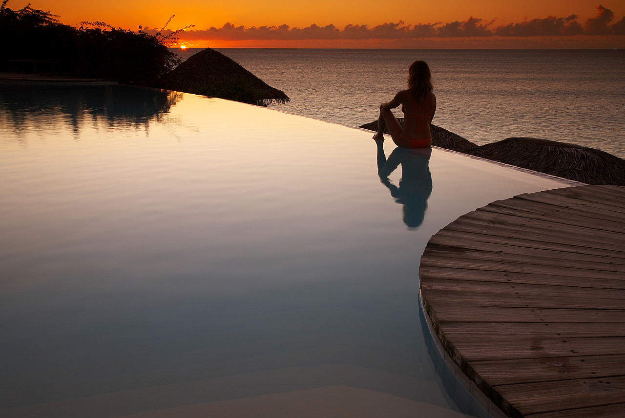 #070120-1 - Woman Relaxing on Infinity Pool at Sunset, Antigua, Caribbean, West Indies