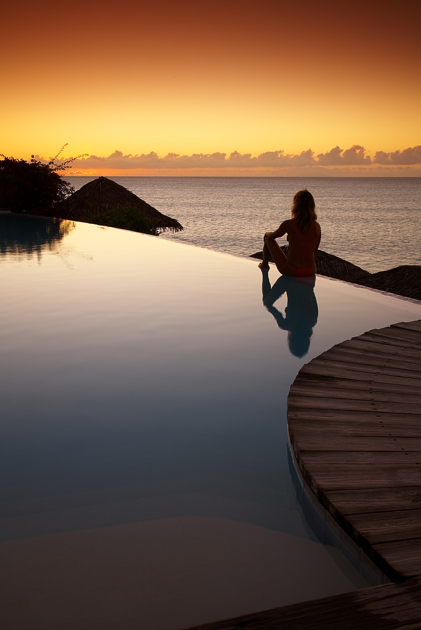 #070120-2 - Woman Relaxing on Infinity Pool at Sunset, Antigua, Caribbean, West Indies