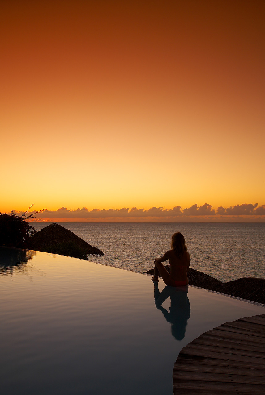 #070120-3 - Woman Relaxing on Infinity Pool at Sunset, Antigua, Caribbean, West Indies