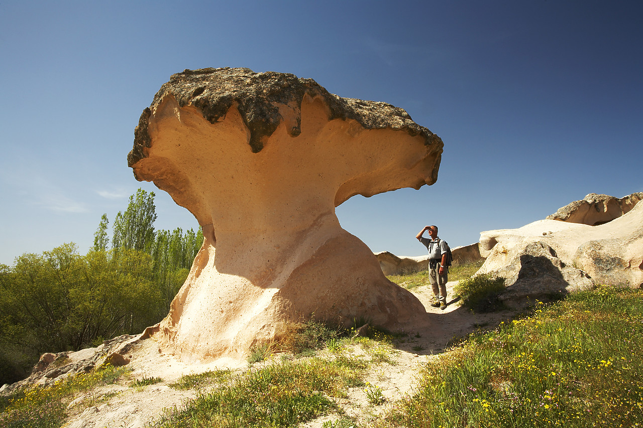 #070237-2 - Man Standing by Mushroom Rock Formation, near Gulsehir, Cappadocia, Turkey
