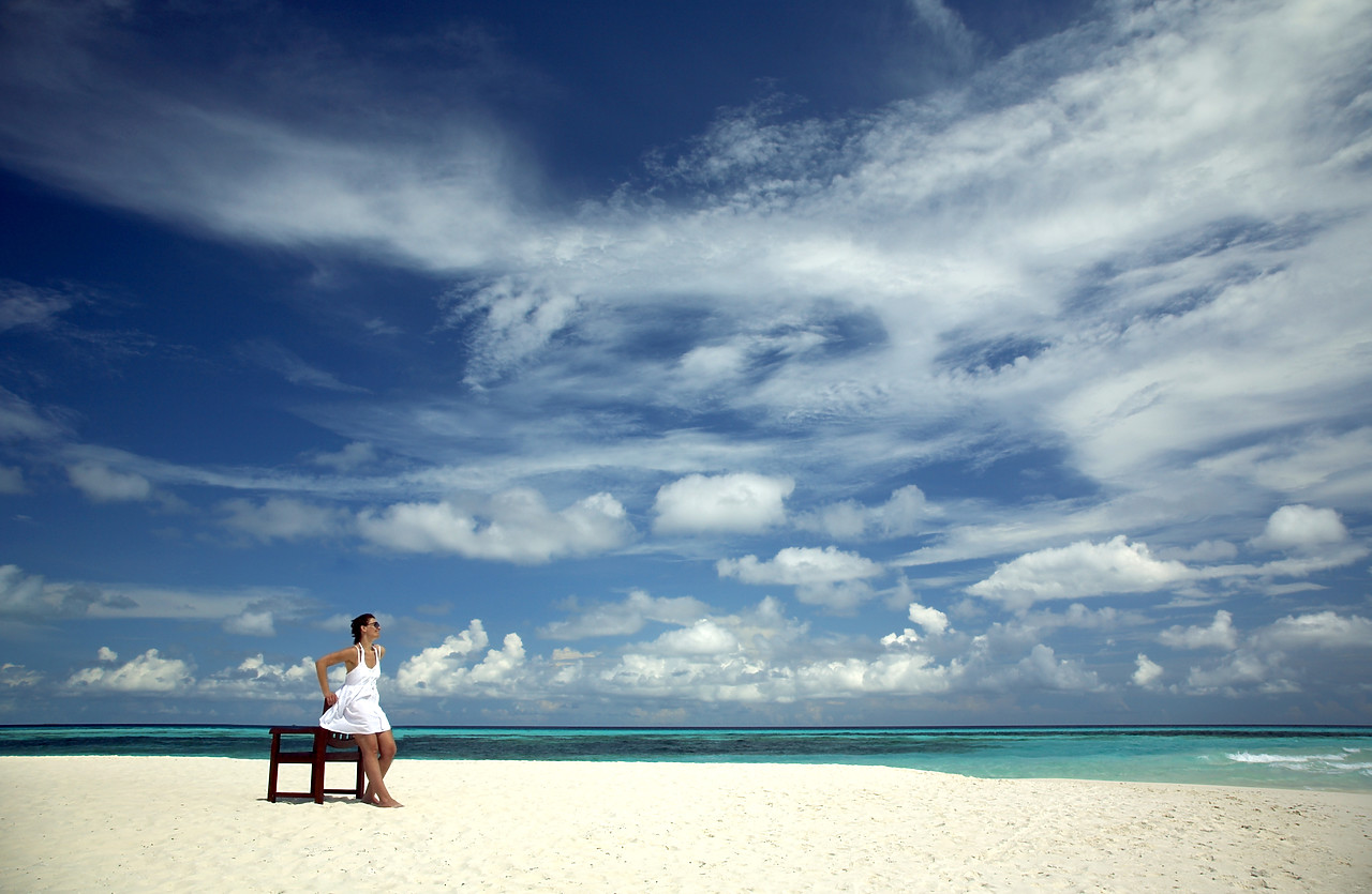 #080059-1 - Woman Leaning on Chair on Beach, Kuredu, Maldives