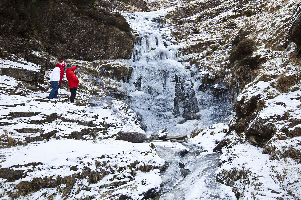 #100058-1 - Couple looking at Frozen Waterfall, Lake District National Park, Cumbria, England