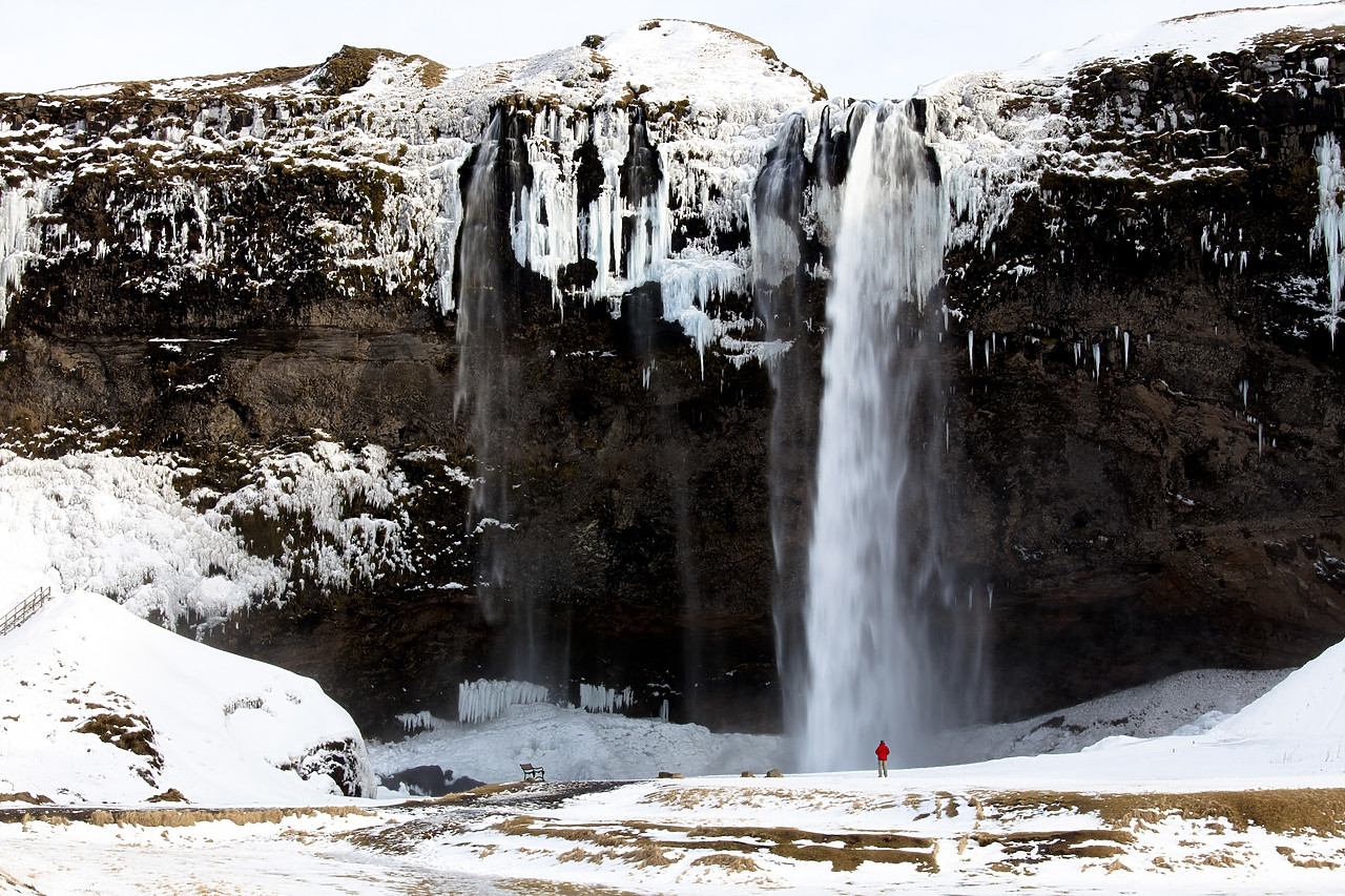 #100124-1 - Person at Seljalandsfoss Waterfall in Winter, Iceland