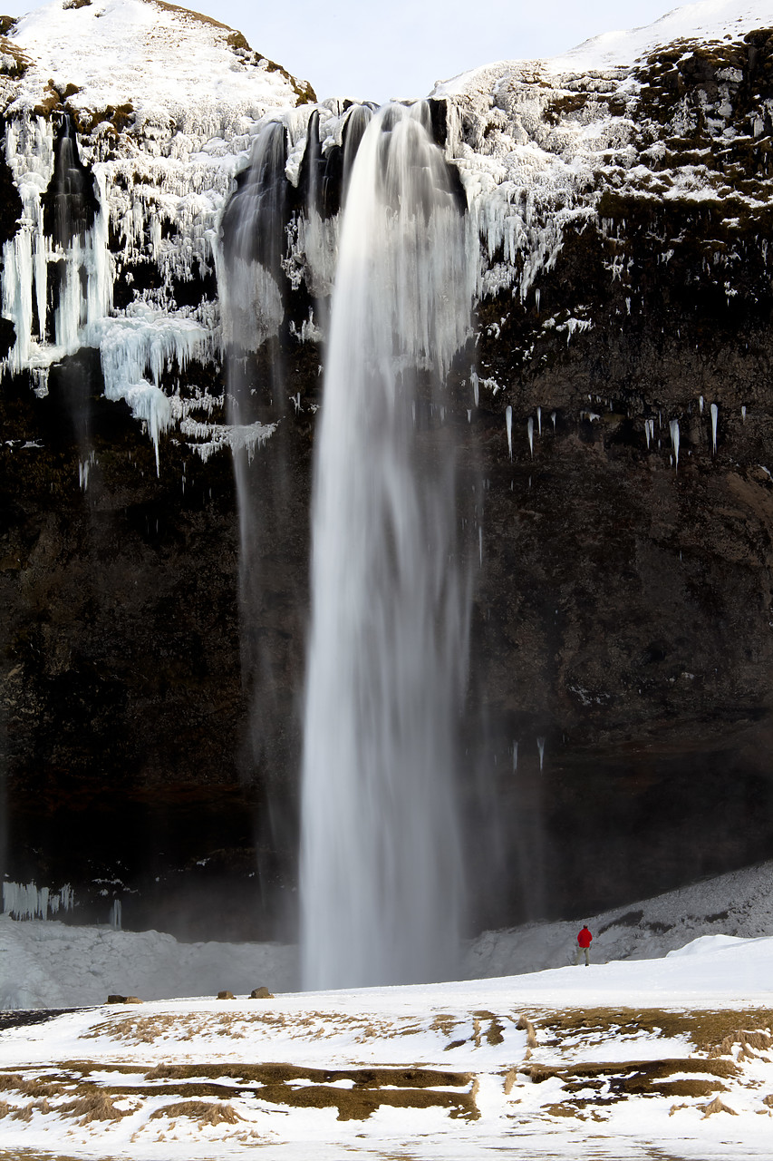 #100124-2 - Person at Seljalandsfoss Waterfall in Winter, Iceland