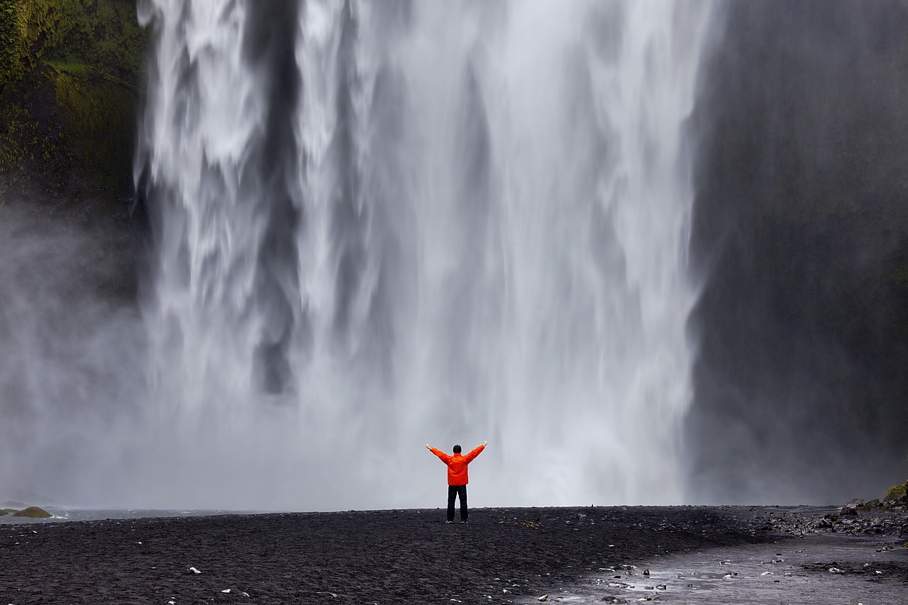 #100322-1 - Man in Front of Skogafoss Waterfall, Iceland