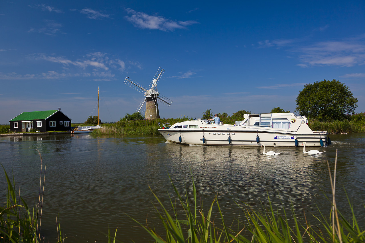 #110216-1 - Cruiser on River Thurne with St. Benet's Mill, Norfolk Broads National Park, England