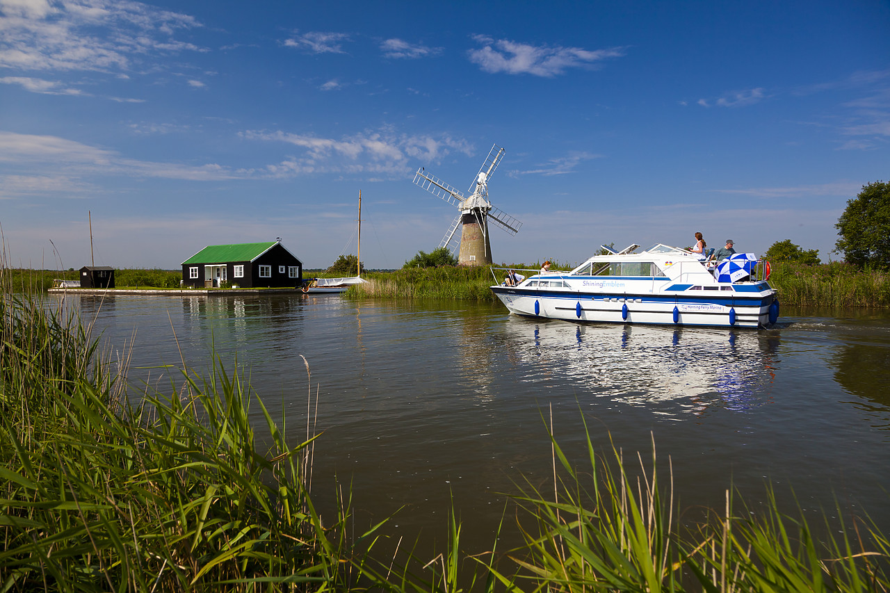 #110217-1 - Cruiser on River Thurne with St. Benet's Mill, Norfolk Broads National Park, England