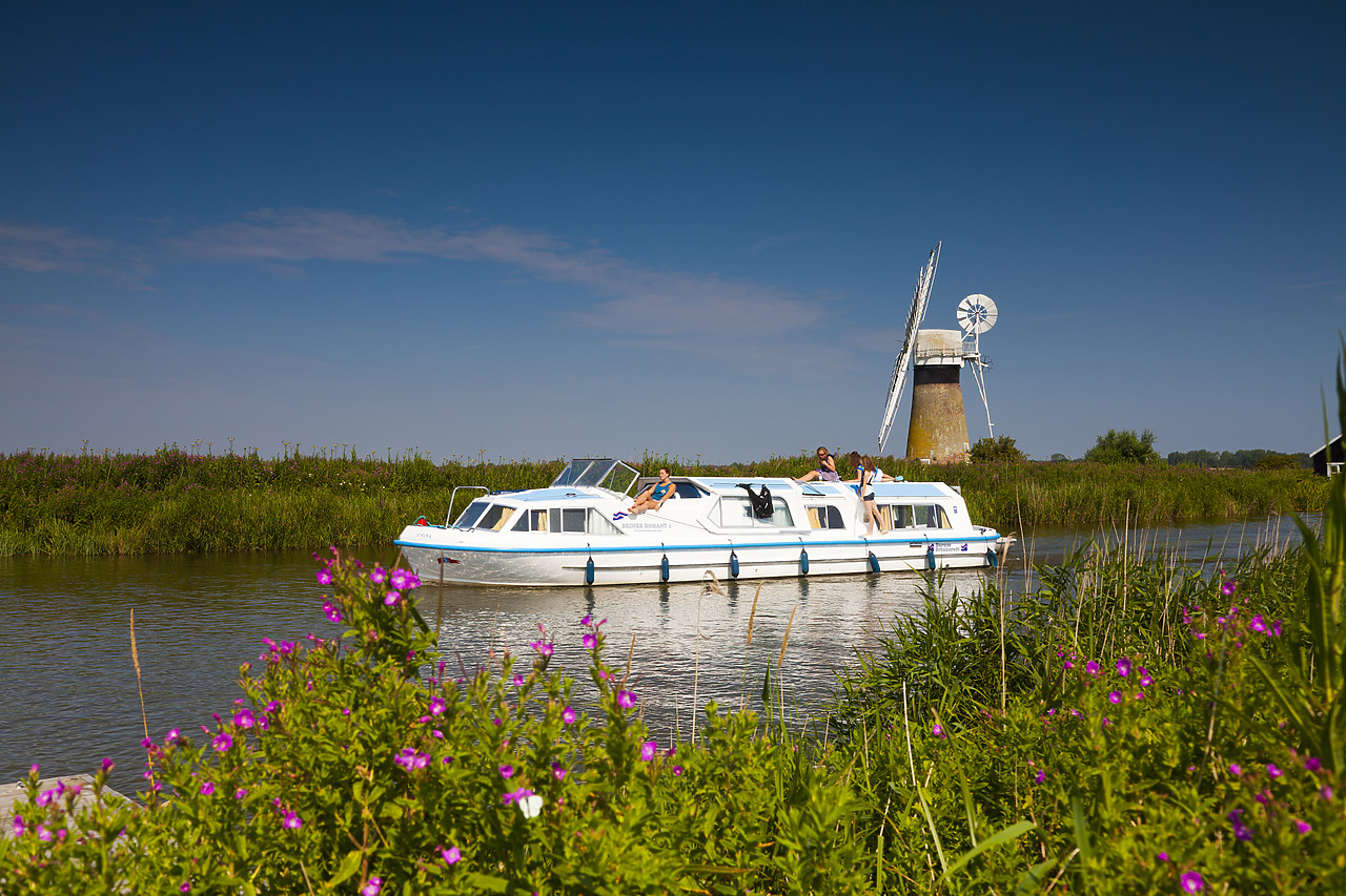 #110219-1 - Cruiser on River Thurne with St. Benet's Mill, Norfolk Broads National Park, England