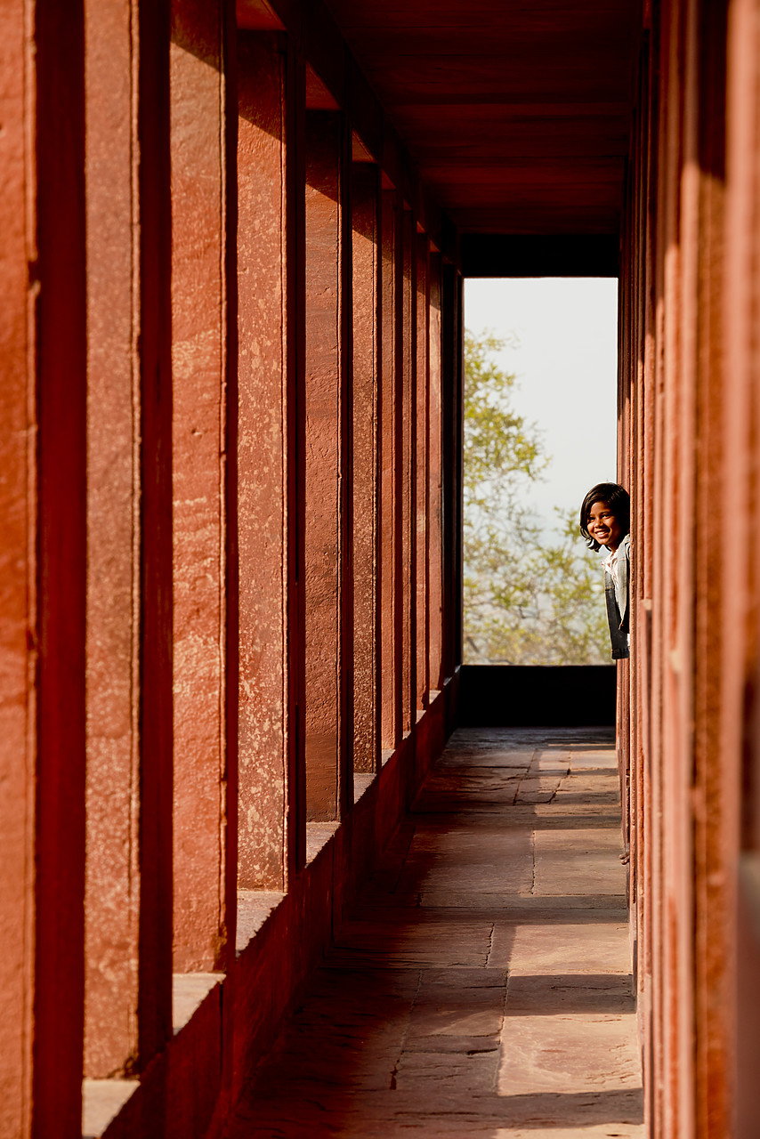 #130149-1 - Young Indian Girl Looking Down Corridor, Jodha Bai's Palace, Fatehpur Sikri, Agra, India