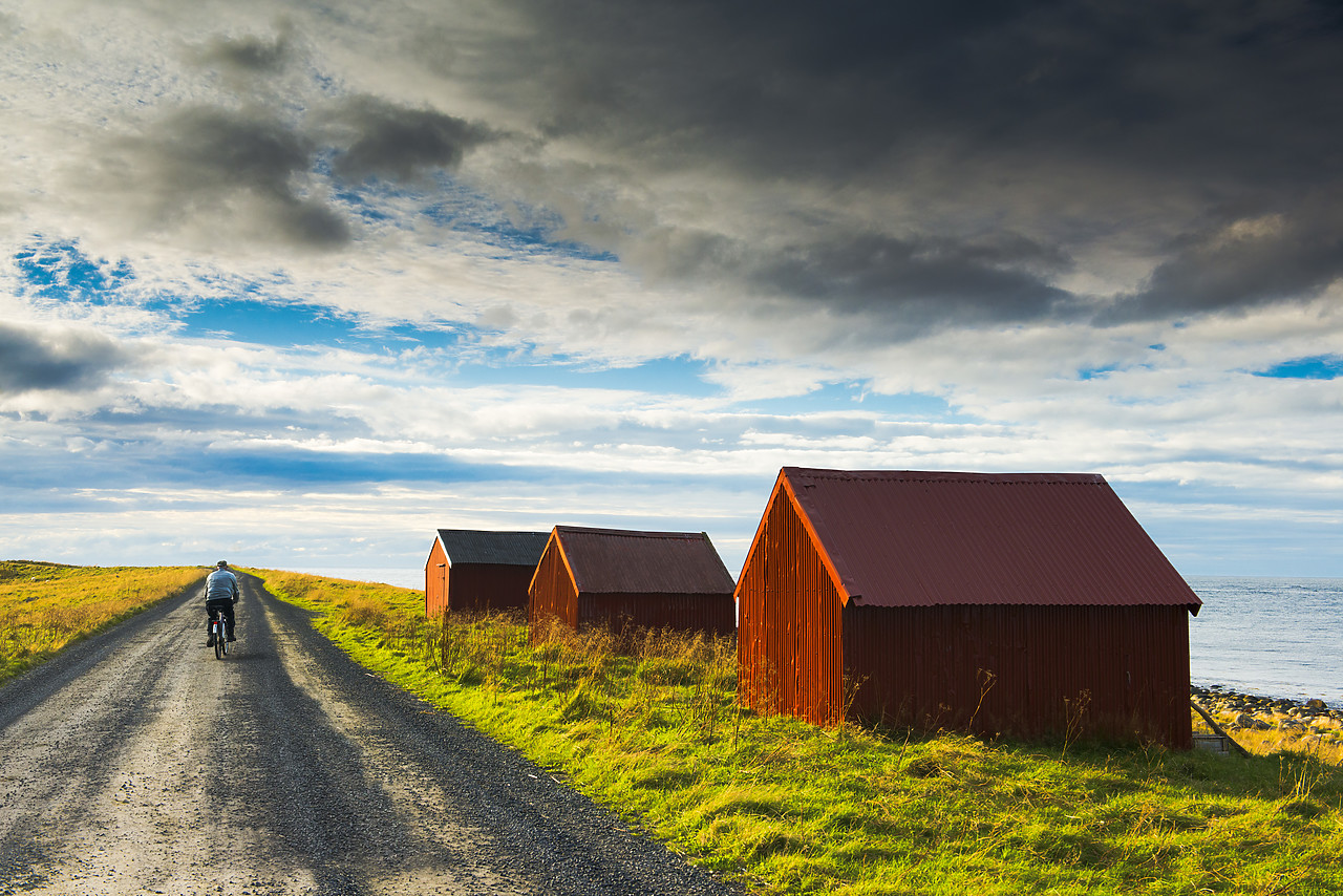 #130311-1 - Man on Bike & Red Fishing Huts, Eggum, Lofoten Islands, Norway