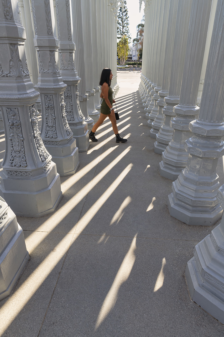 #220028-1 - Woman Walking Between Lamp Posts, Urban Light by Chris Burden, Los Angeles County Museum of Art (LACMA), Los Angeles, California, USA