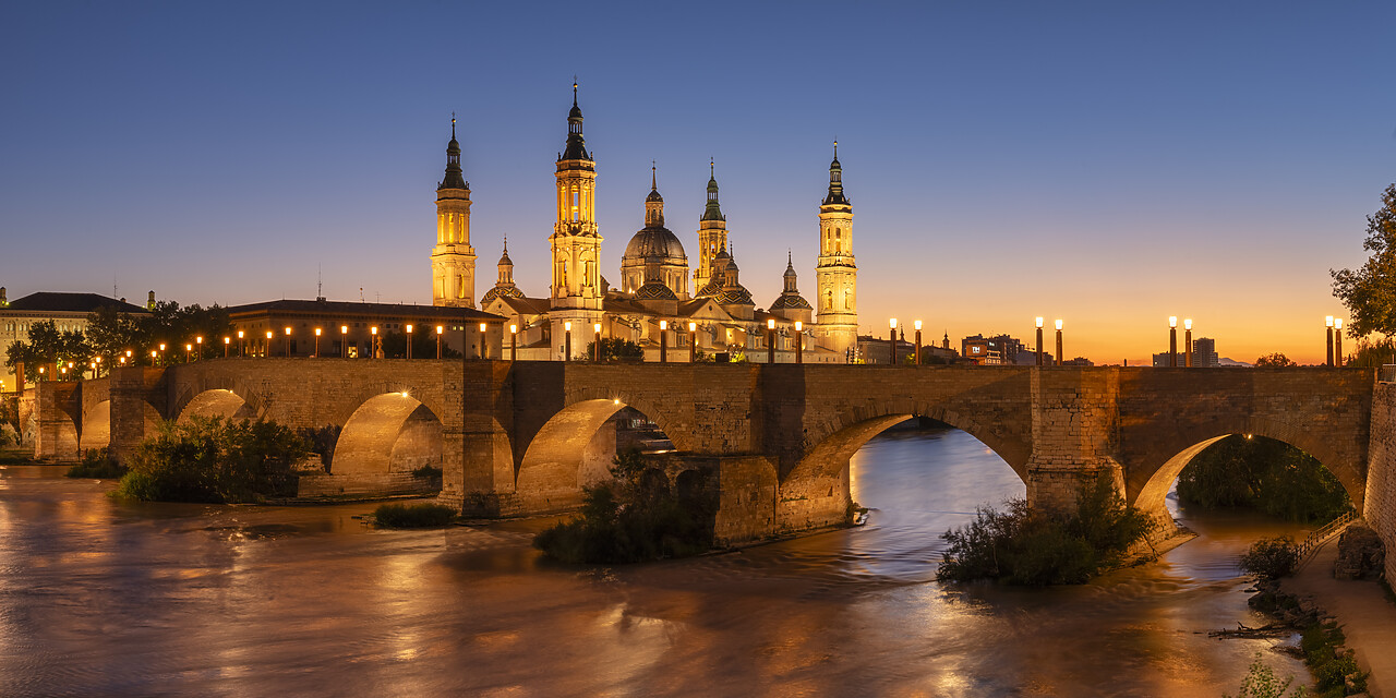 #240516-2 - Puente de Piedra and Cathedral-Basilica of Our Lady of the Pillar along Ebro River at Sunset, Zaragoza, Aragon, Spain