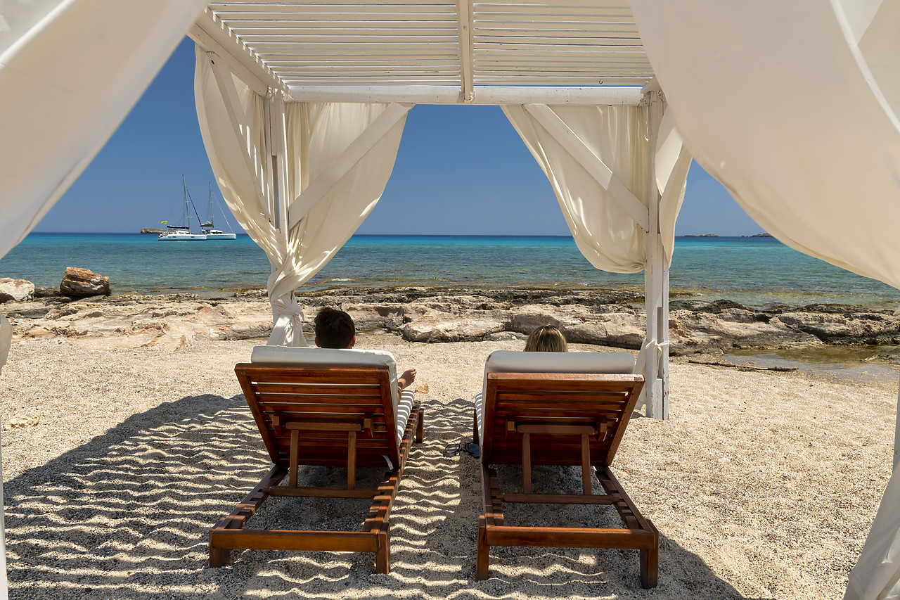 #410286-1 - Cabana & Couple on Sunbeds on Beach,  Rhodes, Dodecanese Islands, Greece